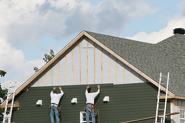 Professional Storm Damage Siding Repair technician working in Saint James, NY